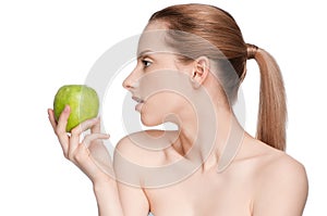 Woman eat green apple