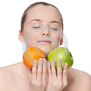 Woman eat green apple and orange