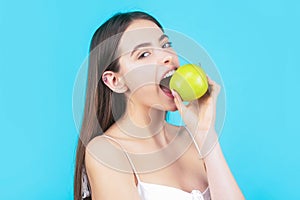 Woman eat green apple. Portrait of young beautiful happy smiling woman with green apples. Healthy diet food. Stomatology