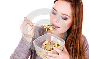 Woman eat oatmeal with dry fruits. Dieting