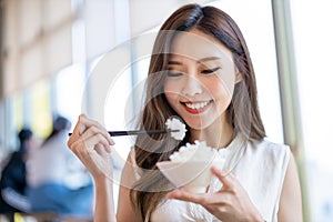 Woman eat rice in restaurant