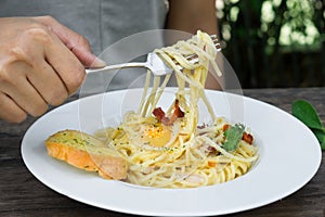 Woman eat spaghetti and garlic bread