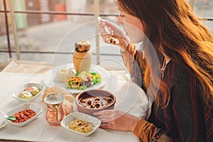 Woman eat turkish food from meatball and pottery kebab