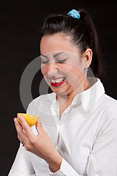 Woman eat yellow lemon