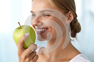 Woman Eating Apple. Beautiful Girl With White Teeth Biting Apple