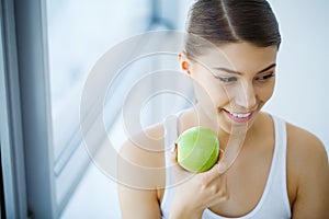 Woman Eating Apple. Beautiful Girl With White Teeth Biting Apple