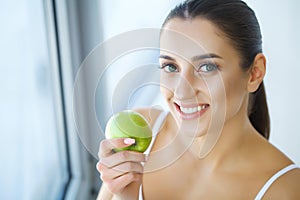 Woman Eating Apple. Beautiful Girl With White Teeth Biting Apple