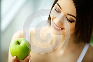 Woman Eating Apple. Beautiful Girl With White Teeth Biting Apple