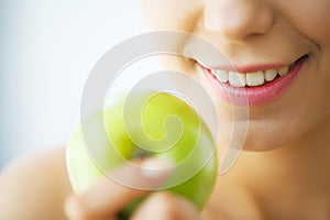 Woman Eating Apple. Beautiful Girl With White Teeth Biting Apple