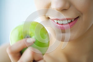 Woman Eating Apple. Beautiful Girl With White Teeth Biting Apple