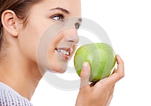 Woman, eating and apple in hand, nutrition and health with snack, diet for weight loss and detox on white background