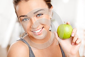 Woman eating apple for healthy, fresh and balanced diet with nutrition, fruit and vitamins. Portrait face of fitness