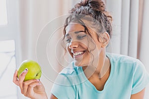 Woman eating apple. Healthy nutrition. Diet. Young woman is eating apple. Healthy eating concept. Vegetarian, vegan, raw