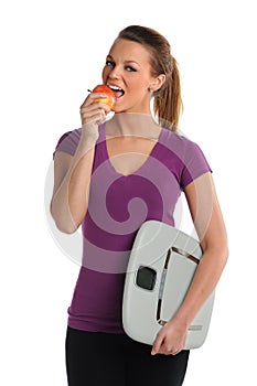 Woman Eating Apple and Holding Scale