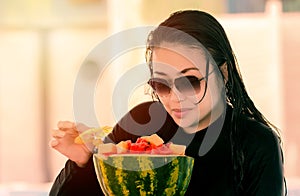 Woman eating assorted fruits in the resort