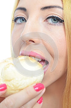 Woman eating bread roll