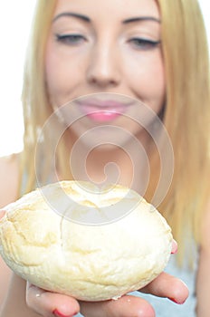 Woman eating bread roll