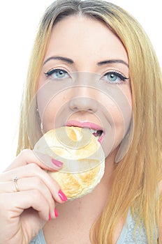 Woman eating bread roll