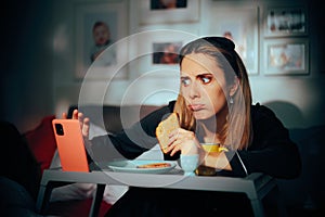 Woman Eating Breakfast While Checking Social Media