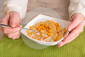 Woman eating breakfast at home