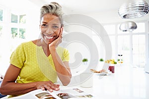Woman Eating Breakfast And Reading Magazine