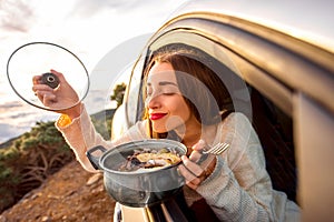 Woman eating in the car