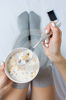 Woman eating cereals in bed