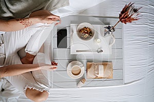 Woman eating cereals in bed