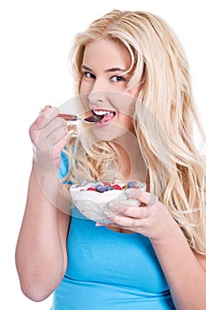 Woman eating cereals with berries