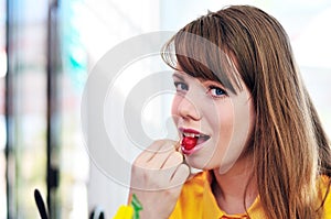 Woman eating cherry