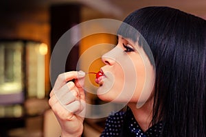 Woman eating cherry