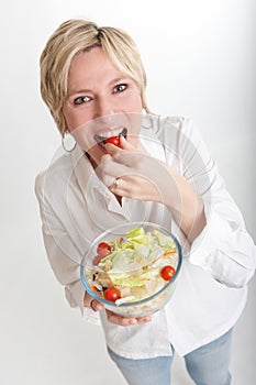 Woman eating a cherry tomato