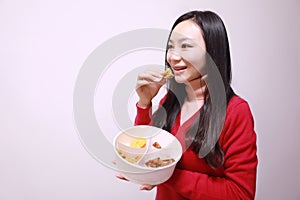 Woman eating chicken meat