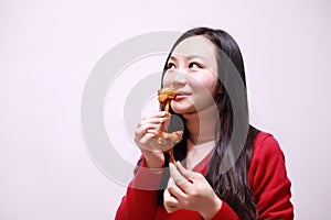 Woman eating chicken meat