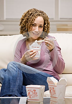 Woman eating chinese take-out food photo