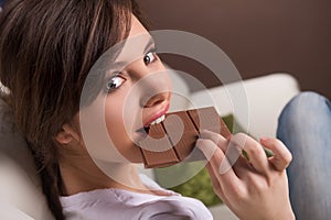 Woman eating chocolate.