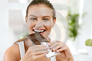 Woman Eating Chocolate. Beautiful Girl With Sweets.