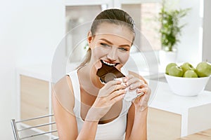 Woman Eating Chocolate. Beautiful Girl With Sweets.