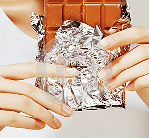 Woman eating chocolate, close up hands with