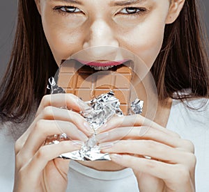 Woman eating chocolate, close up hands with
