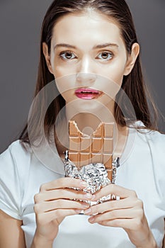 Woman eating chocolate, close up hands with