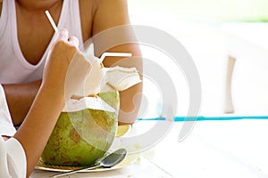 Woman is eating coconut