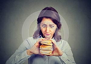 Woman eating craving a tasty triple burger