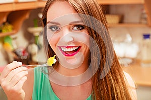 Woman eating cream cake with fruits. Gluttony.