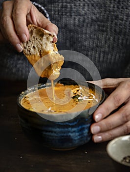 Woman eating a creamy pumpkin soup