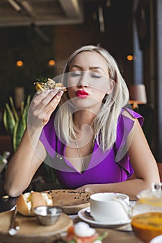 Woman eating danish smorrebrod in restaurant photo