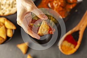 A woman is eating delicious Indian food