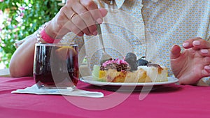 Woman eating dessert in a cafe or restaurant. Close up.