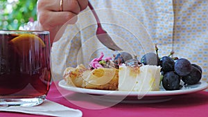 Woman eating dessert in a cafe or restaurant. Close up.