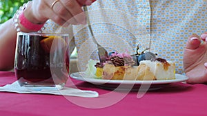 Woman eating dessert in a cafe or restaurant. Close up.